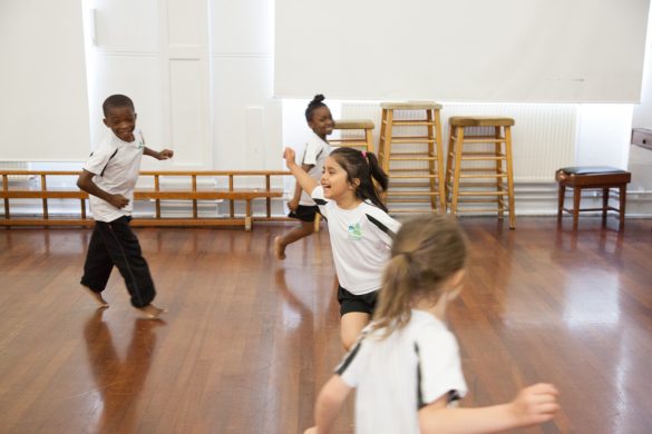 Children taking part in a warm-up in a real PE lesson