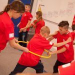 Children taking part in a real PE game called 'River crossing'