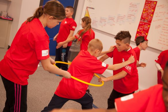 Children taking part in a real PE game called 'River crossing'